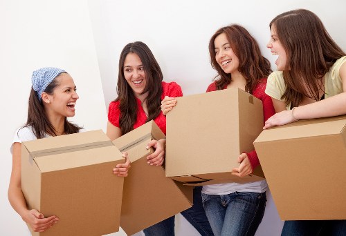 Moving boxes and furniture being loaded for a Canary Wharf home move