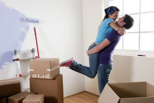 Furniture being moved safely through a Canary Wharf apartment hallway