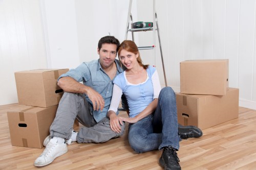 Loading household boxes and furniture into a moving truck in Canary Wharf
