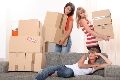 Local packing team handling fragile items in a high-rise building